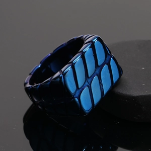 Detailed macro view of blue titanium steel ring with unique geometric scale texture