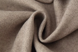 Macro shot of high-quality camel wool fabric texture with soft fiber detail and premium feel