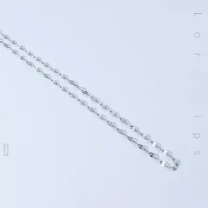 Macro detail of the polished silver snake bone chain with a sleek metallic luster finish