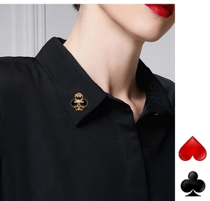 Detailed view of a gold clover collar pin with pearl inlay and black enamel finish