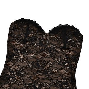 Close-up of black lace bustier detailing with intricate floral embroidery and textures