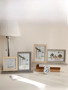 Close-up of modern dual wooden photo frame set with minimalist tiered design on tabletop