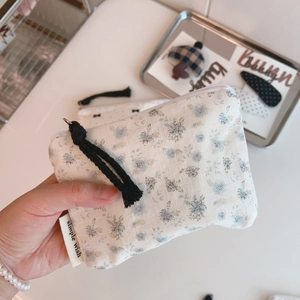 Close-up of floral cotton pouch with zipper and Simple Wish label for small items