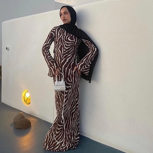 Close-up of zebra pattern long sleeve maxi dress with refined stitching and textured fabric