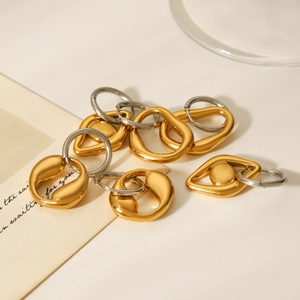 Detailed shot of mixed gold and silver geometric stainless steel drop earrings on cards