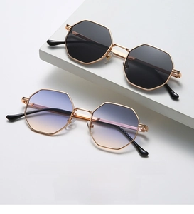 Detail of classic gold metal hexagonal sunglasses with black and blue-yellow gradient lenses