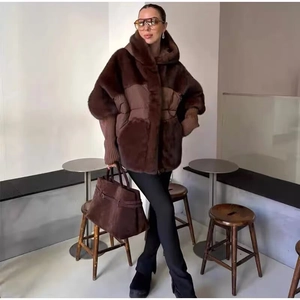 Close-up of deep brown patchwork jacket featuring faux fur and ribbed cuff details