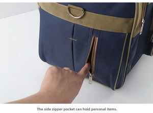 Detail of high-density navy travel bag showing side zipper pocket and metal D-ring attachment