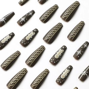 Christmas gingerbread man and snowflake press-on nails in long coffin shape with matte brown