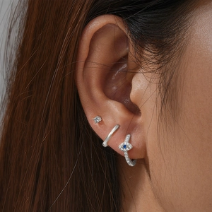 Close-up of S925 silver evil eye earring set with blue crystals and sparkling stones