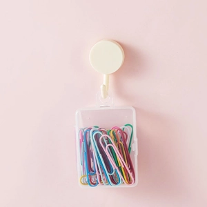 White adhesive hook with clear storage box filled with colorful macaron paper clips