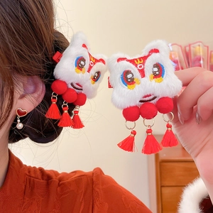 Detailed close-up of Chinese New Year lion dance hair clips with red tassels and fur