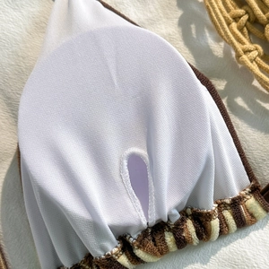 Detail view of breathable mesh lining and circular padded cups on striped bikini top