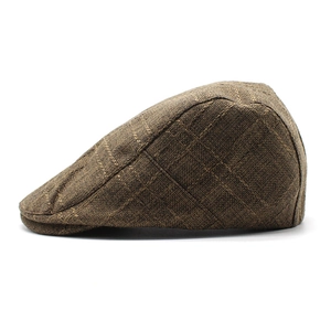 Detail view of brown checkered cotton linen flat cap with breathable textured fabric