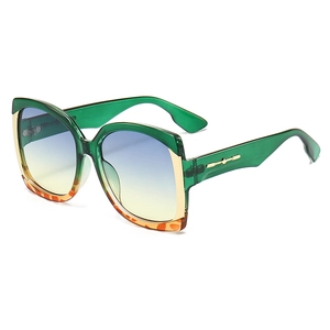 Modern oversized square sunglasses with green frames and gradient blue lenses