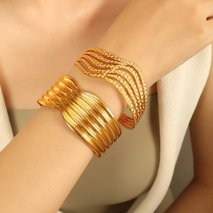 Elegant gold titanium steel cuff bracelet set featuring wide textured and wavy wave patterns