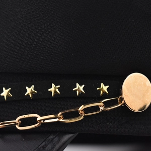 Detail of gold star studs and metal chain on black PU leather military cap