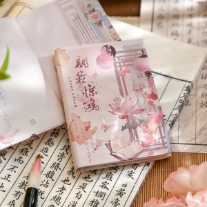 Pink A7 notebook with classic lotus illustration and oriental calligraphy on desk
