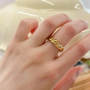 Elegant twisted gold-plated S925 sterling silver ring worn on hand with minimalist aesthetic