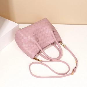 Handwoven pink PU leather mini bucket bag with gold hardware and removable shoulder strap