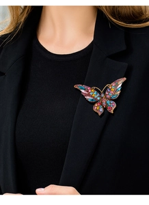 Detail of colorful butterfly brooch with crystals on a black suit jacket lapel