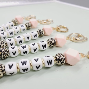 Detail of MAMA beaded keychain with silicone leopard print and geometric beads