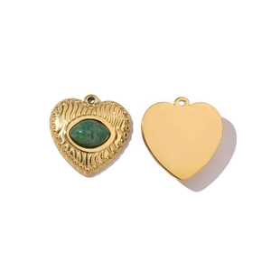 Detailed view of heart pendants featuring green natural stone and polished gold finish