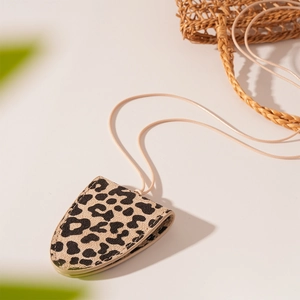 Detail of leopard print leather neck pouch showing fine stitching and classic texture
