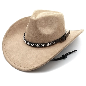 Detail of beige suede cowboy hat showing wide brim, brown braided band, and chin strap