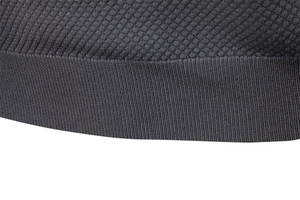 Macro view of dark grey pineapple knit texture and stitching on business polo shirt
