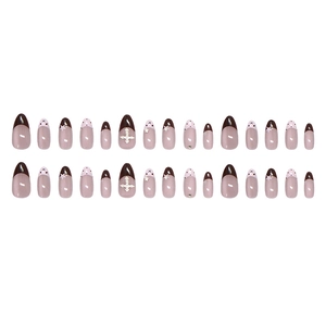 French pink and brown almond press-on nails with star patterns and cross rhinestones