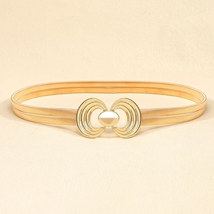 Detailed shot of golden elastic spring waist chain with decorative bow buckle