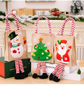 Detail of Christmas gift bags featuring cartoon snowman and Santa with striped legs
