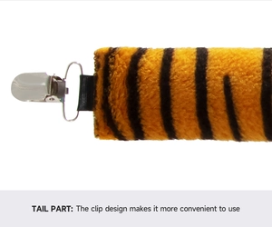 Detail view of the plush orange tiger tail with a metal duckbill clip and elastic strap