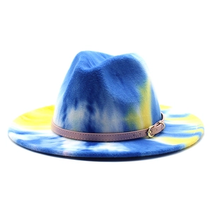 Tie-dye blue and yellow wide brim fedora hat with pink leather band and metal buckle