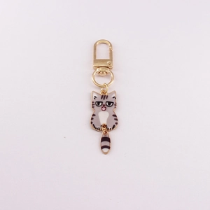 Close-up of a mini gray striped cartoon cat keychain with a gold lobster clasp