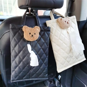 Car seat back tissue holder made of quilted leather with plush bear decoration