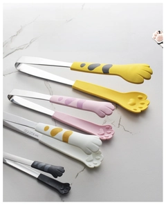 Detailed view of cat paw silicone food tongs in yellow, pink, white, and black colors