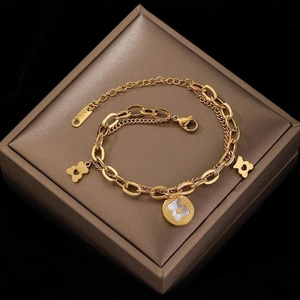 Golden double-layer chain bracelet featuring bear pendants and white mother of pearl