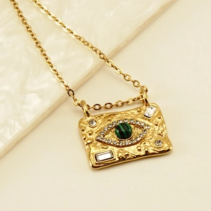 Detailed close-up of 18K gold plated evil eye pendant with malachite and crystals