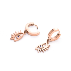 Detailed close-up of rose gold evil eye earrings with a sparkling blue zircon stone