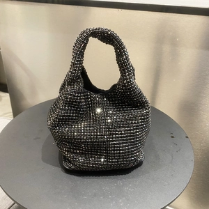 Detail of black rhinestone evening bucket bag with shimmering crystals and soft handle