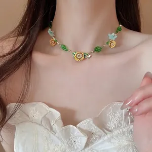 Beaded sunflower necklace set with bee pendants on a model wearing white lace