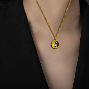 Vintage stainless steel yin yang pendant necklace with gold chain on model neck