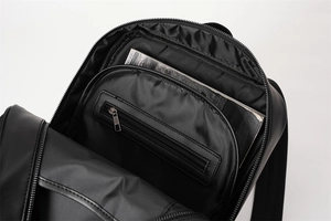 Interior view of black woven backpack showing spacious main compartment and zipper pocket