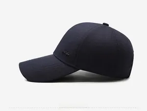 Detailed side view of navy blue baseball cap with curved brim and Style metal logo