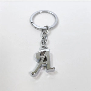 Close-up of silver metal letter A keychain with high-gloss finish on white background