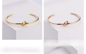Detailed comparison of knot-style open bangles in polished gold and rose gold finishes