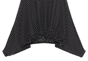 Detail of black and white polka dot fabric with elastic hem and light texture