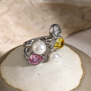 Detail of 18k gold plated ring with colorful zircons and three white pearls